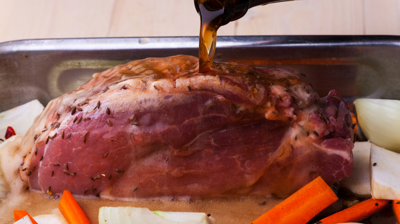 pouring beer over beef roast