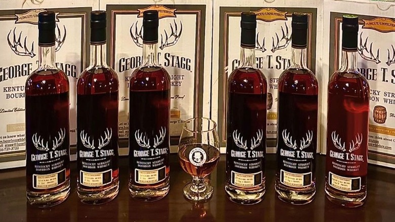 Six bottles and a glass of George T. Stagg bourbon