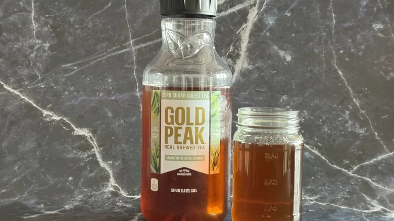 A bottle of Gold Peak next to a jar of sweet tea.