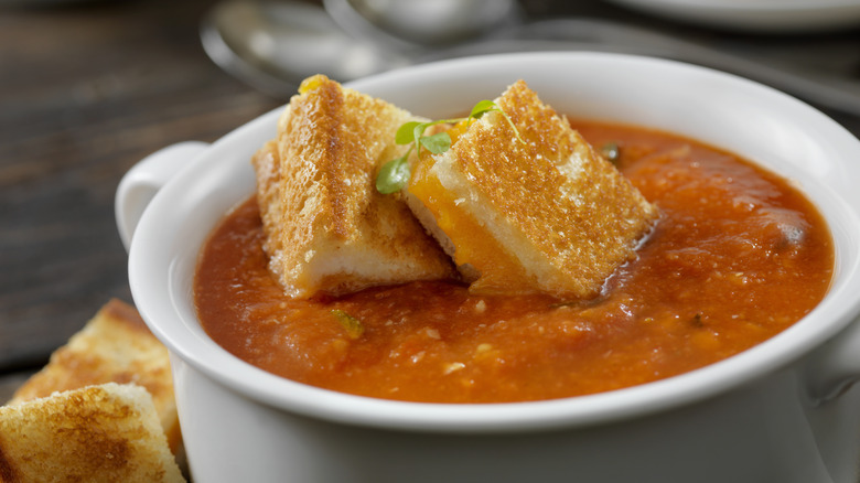 Bowl of tomato soup with grilled cheese croutons