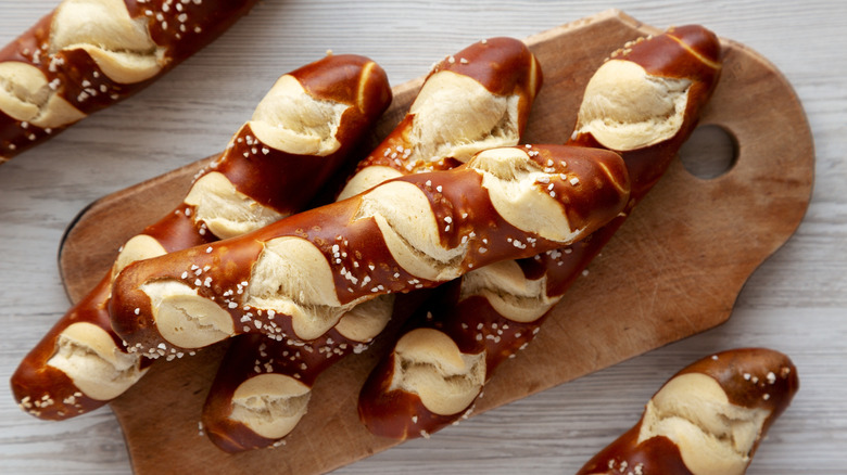 soft pretzel twists on wood board with salt