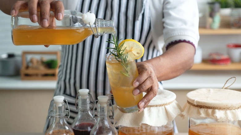 person pouring kombucha