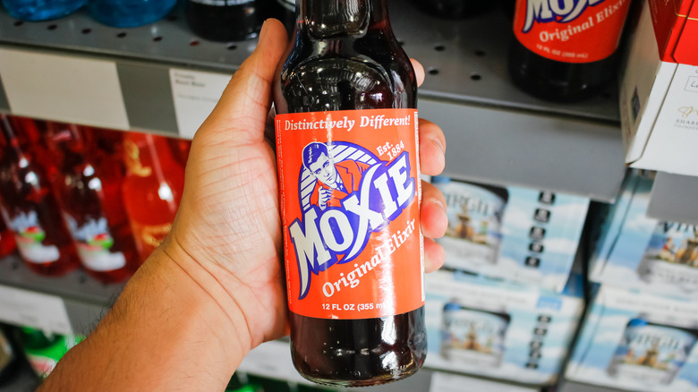 hand holding moxie beverage