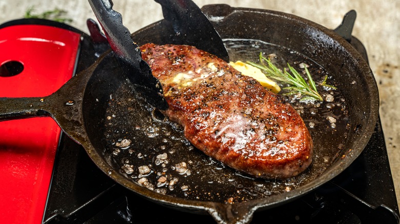 butter basted sirloin in the pan