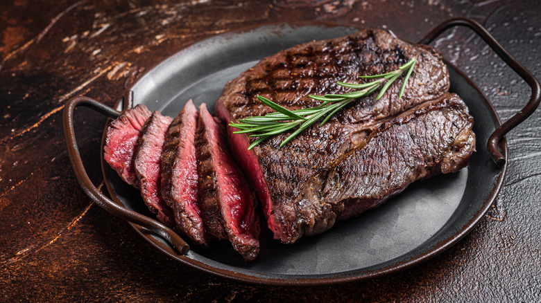 rare sirloin steak on metal pan