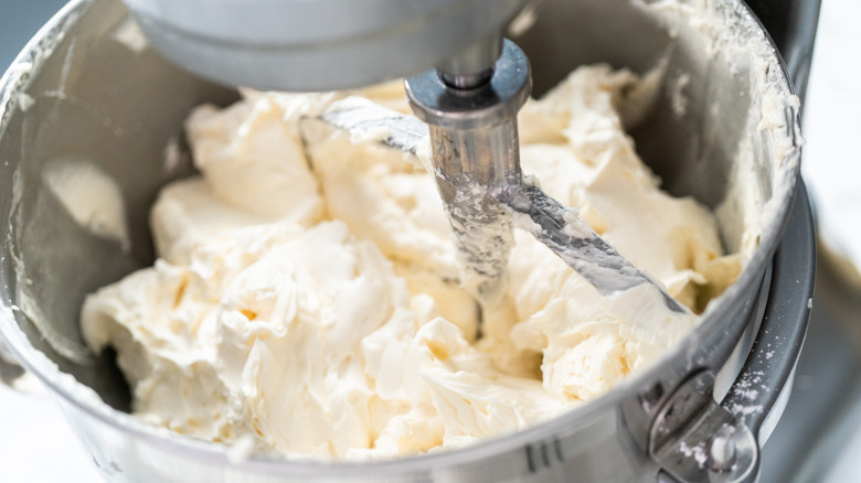 mixing buttercream frosting in a bowl