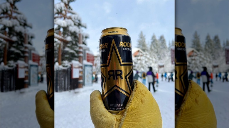 Rockstar can held on ski slope