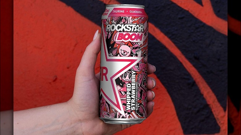 Hand holding Rockstar Boom can