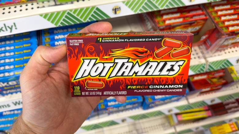 hand holding box of Hot Tamales 