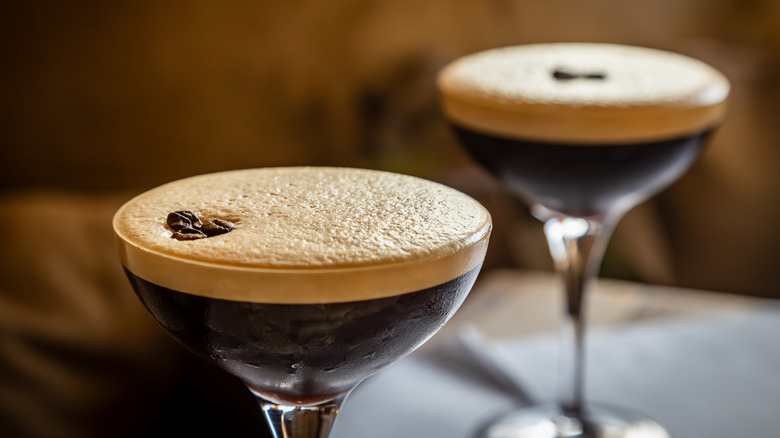 two espresso martinis with garnish beans on bar