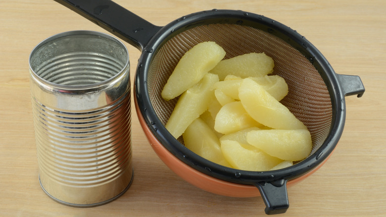 Canned Bartlett pears in a strainer