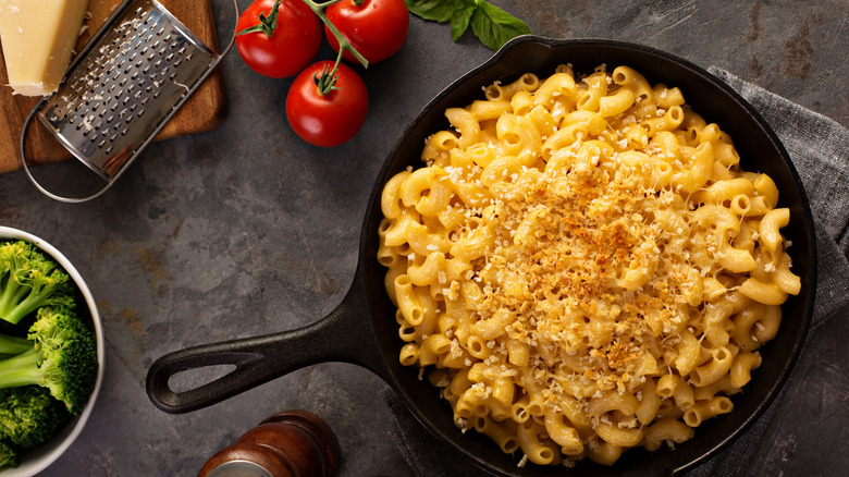 bowl of macaroni and cheese next to tomatoes