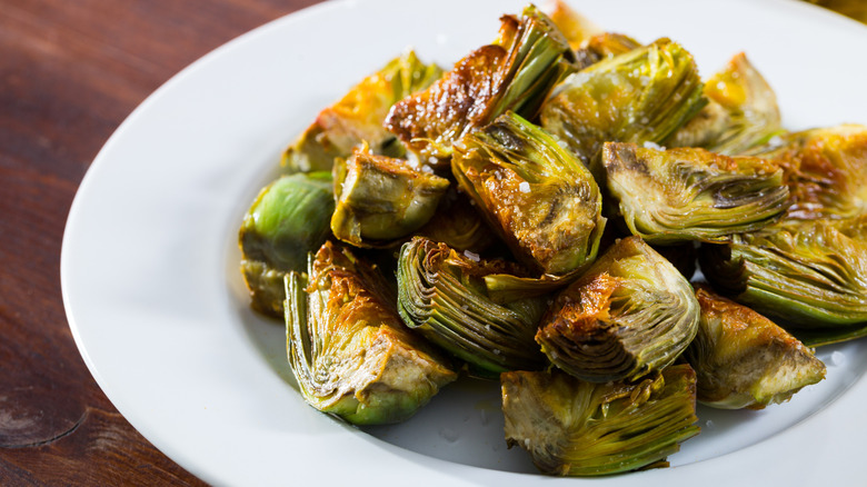 caramelized artichokes on a white plate