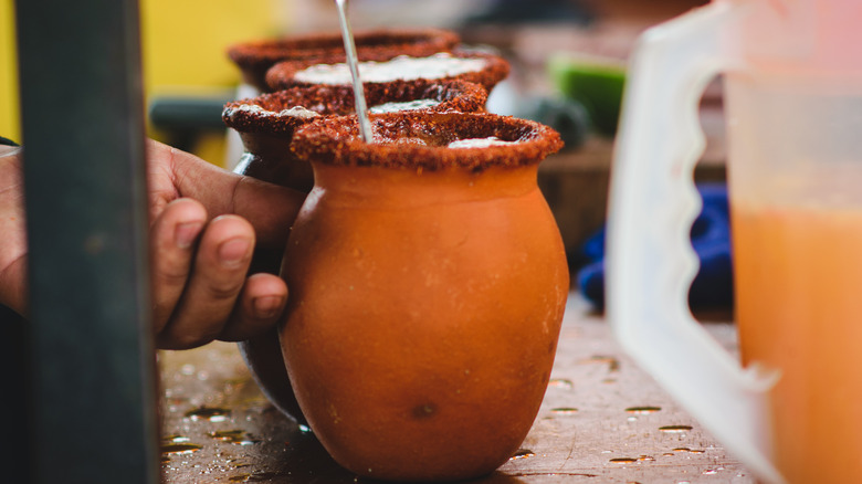 stirring cantarito with spiced rim
