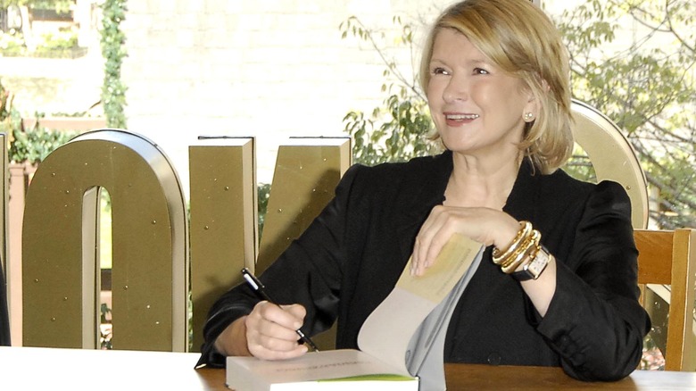 Martha Stewart signs a cookbook