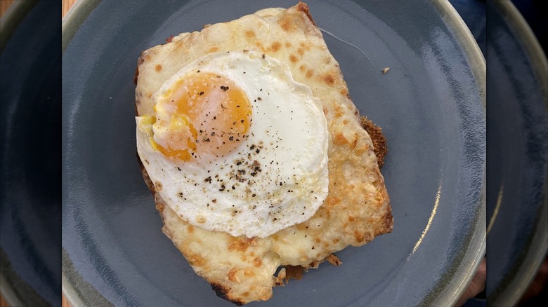 Open-faced grilled cheese topped with a fried egg