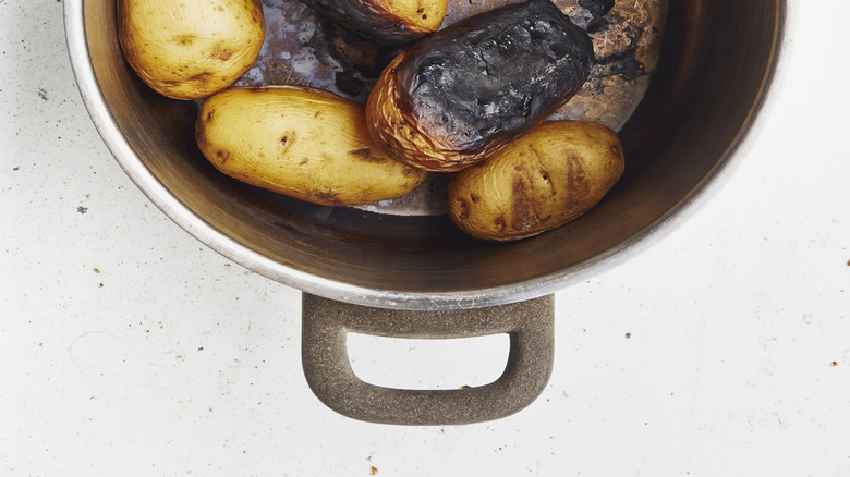 burnt white potatoes in the bottom of a pot