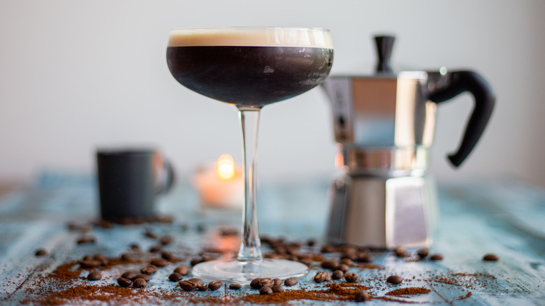 Espresso martini in front of a coffee percolator 