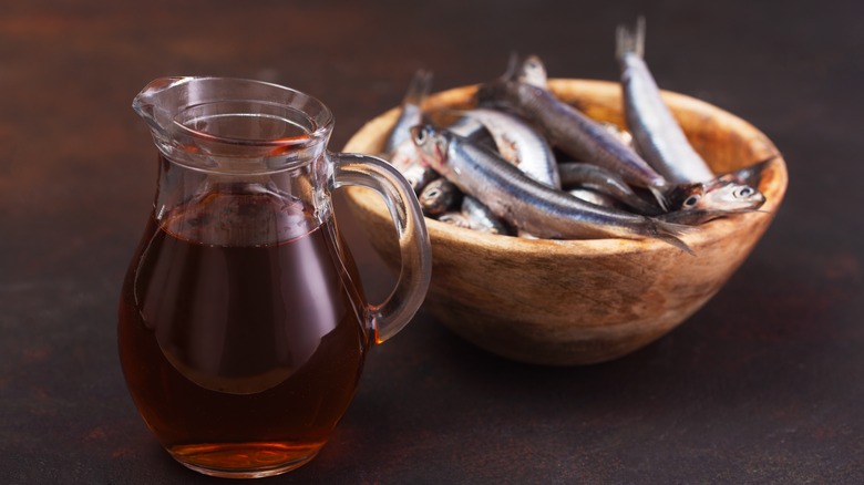 fish sauce in pitcher with bowl of fish