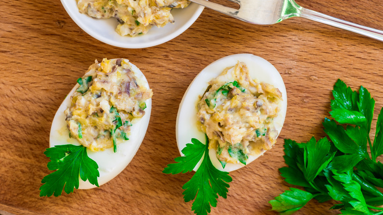 deviled eggs with parsley on table