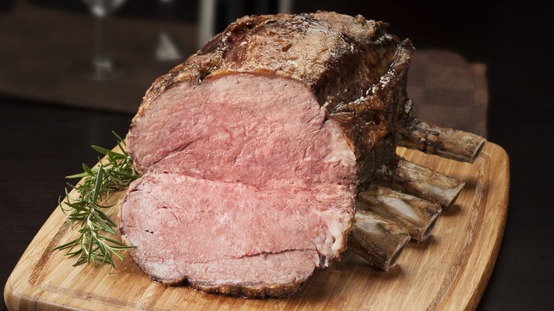 a cooked standing rib roast on a wooden cutting board