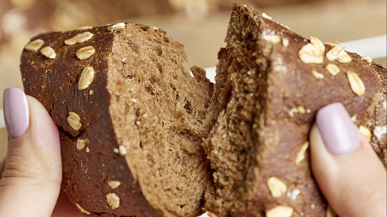 hand holding brown bread 