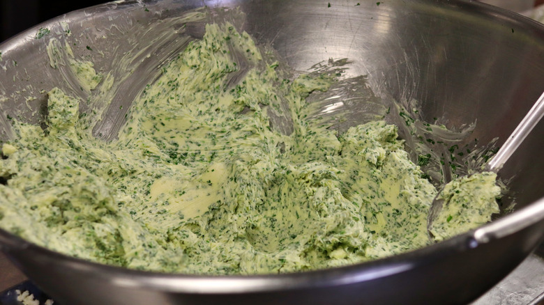 compound butter with herbs in mixing bowl