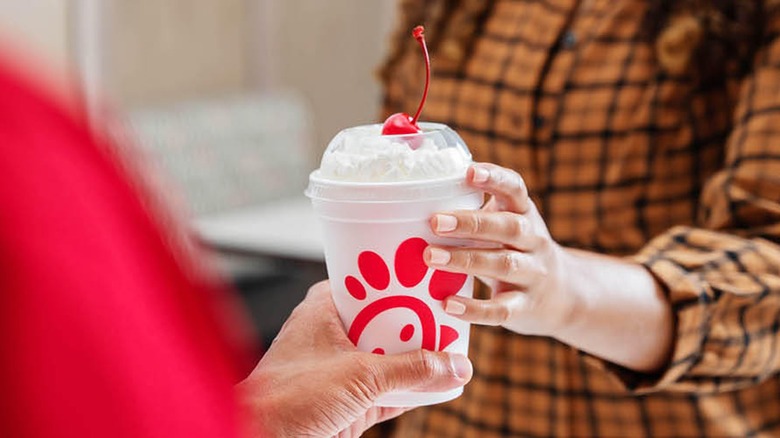 handing over whipped cream drink at Chick-fil-A