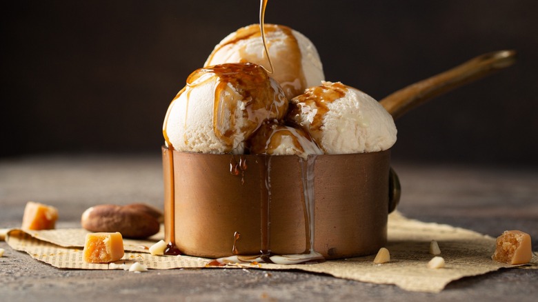 White ice cream scoops in a copper pot