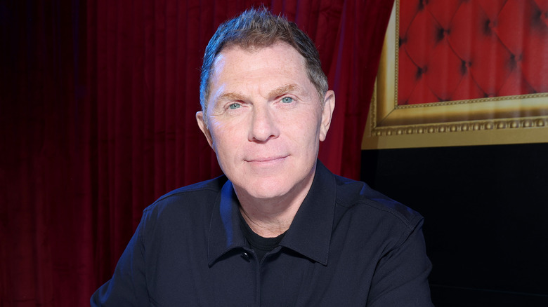 bobby flay smiles in black button-up shirt