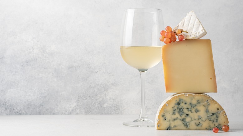 white wine and stack of cheeses