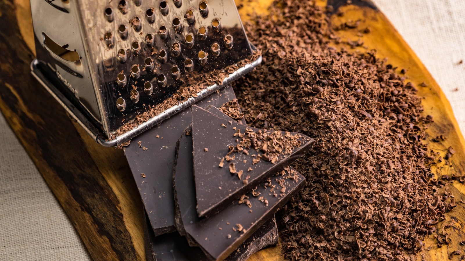 https://www.tastingtable.com/img/gallery/the-clever-hack-to-grate-chocolate-without-creating-a-mess/l-intro-1695682015.jpg
