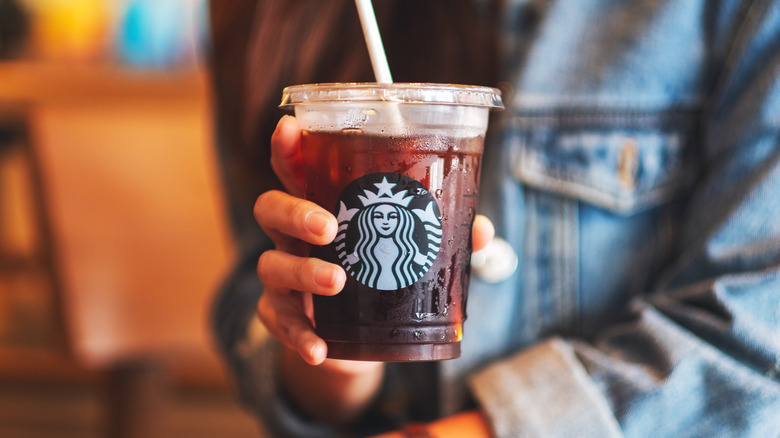 hand holding starbucks iced coffee