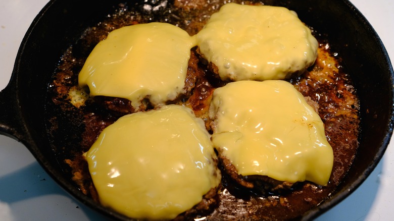 The Clever Tip For Melting Cheese When Making Stovetop Burgers