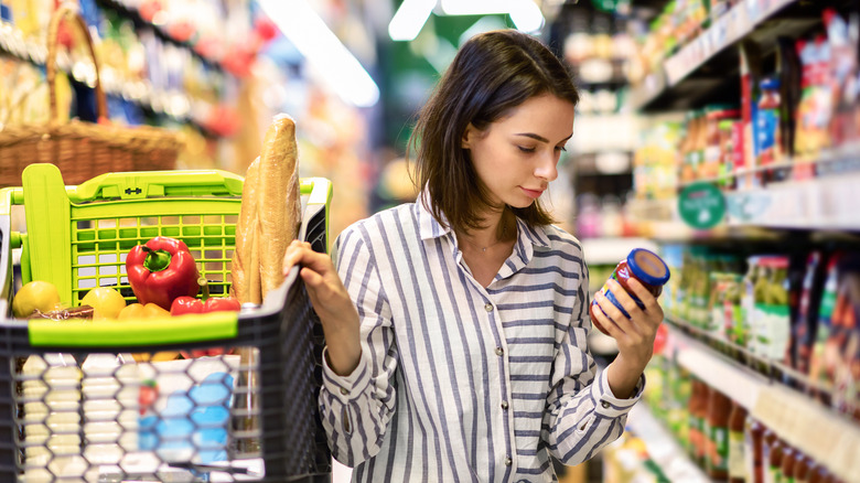 woman reading label at store