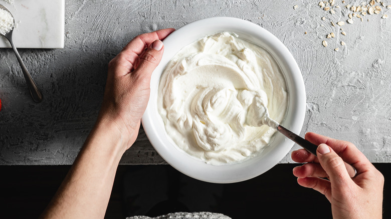 Stirring homemade yogurt in bowl