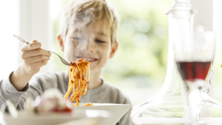 Boy eating pasta