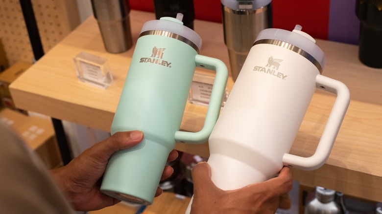 shopper holding Stanley tumblers