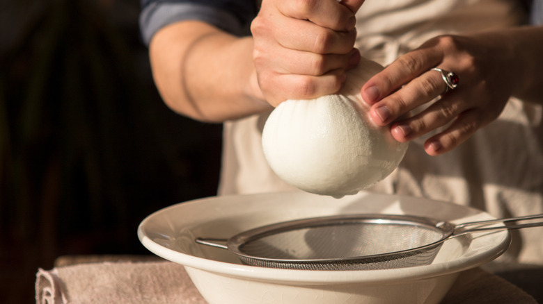 woman's hands using cheesecloth 