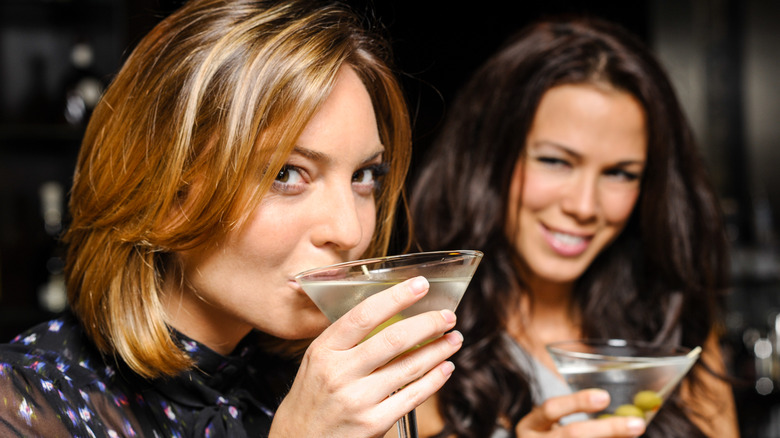 Two women sipping cocktails