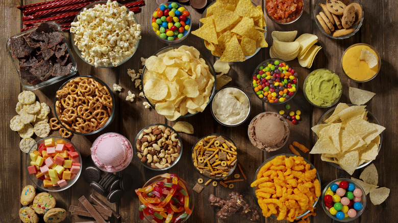 bowls of assorted sweet and savory snacks and dips