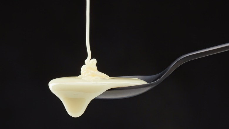 cream pouring on to spoon