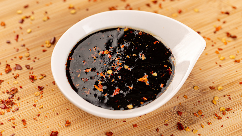 A bowl of teriyaki sauce on a wood table