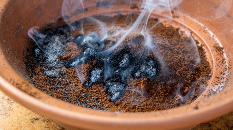 Close-up of burning coffee grounds in a pot