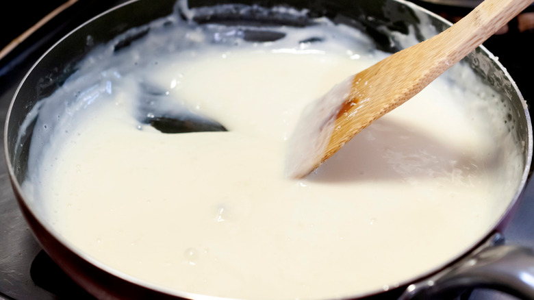 A wooden spoon stirring a roux