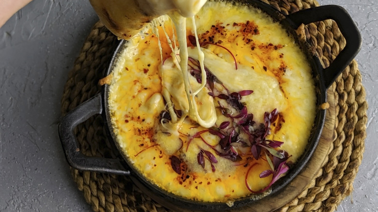 cheese dip n a skillet with pita