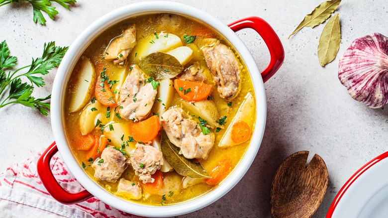 Soup with chicken, carrots, and herbs