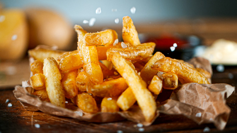 salt falling onto fries