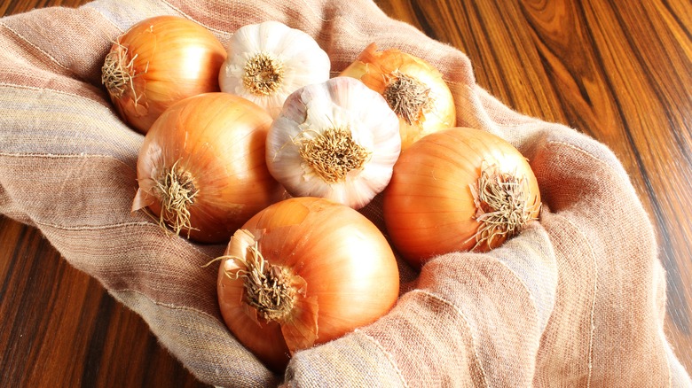 Garlic bulbs and onions in a basket