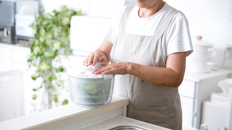 woman using salad spinner